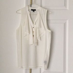White sleeveless ruffle blouse